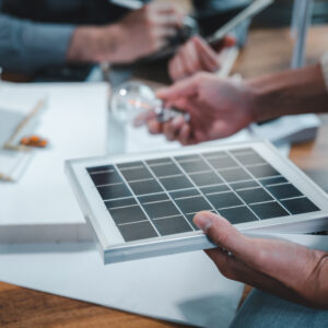 A student holds a mini grid built based on photovoltaic principles.