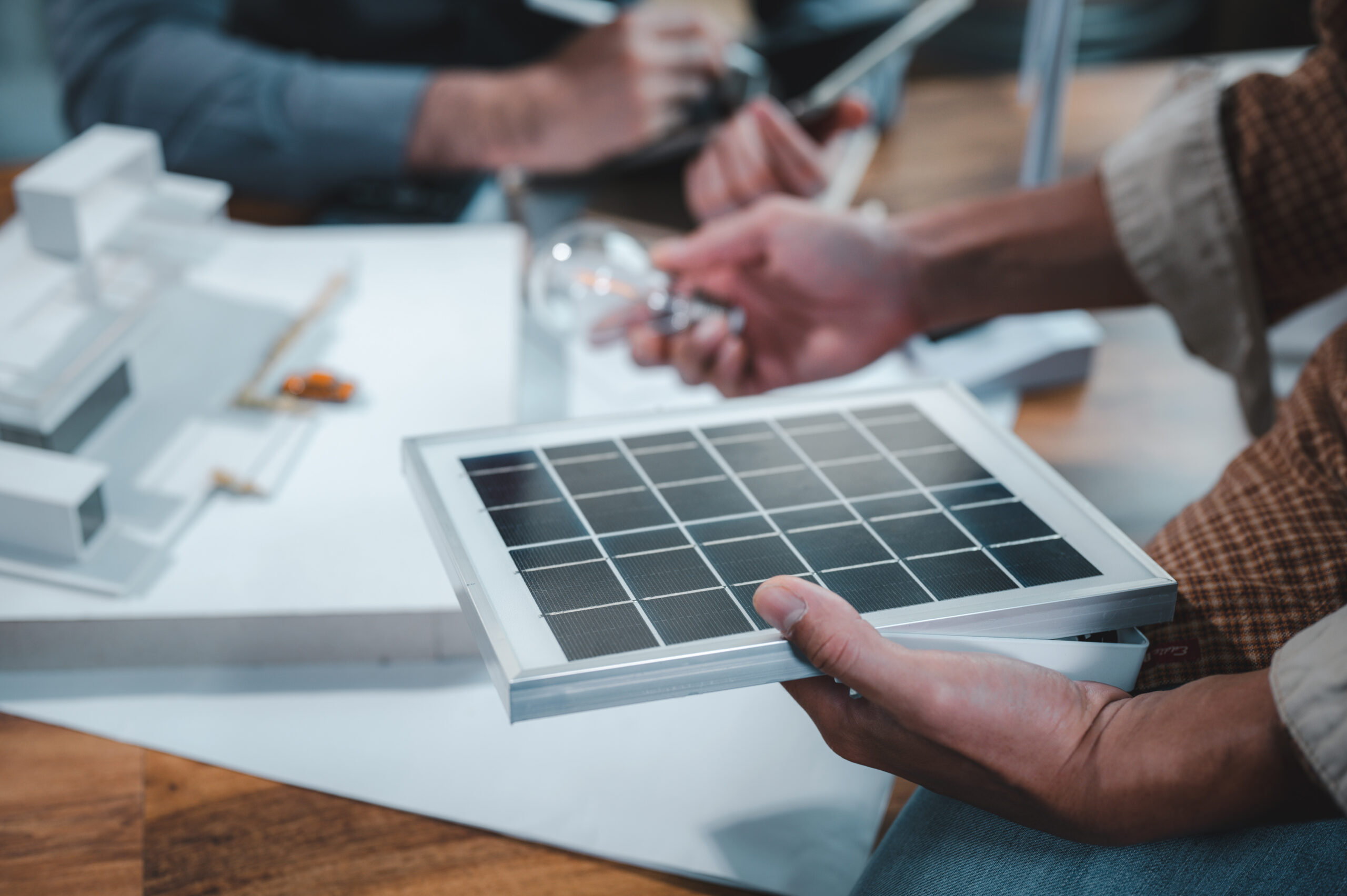 A student holds a mini grid built based on photovoltaic principles.